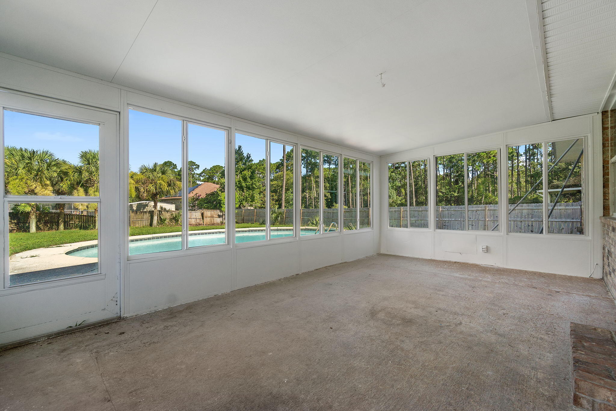 2005 Cardinal Lane Navarre, FL 32566 - Photo 40 of 63 a view of an empty room with wooden floor and a window