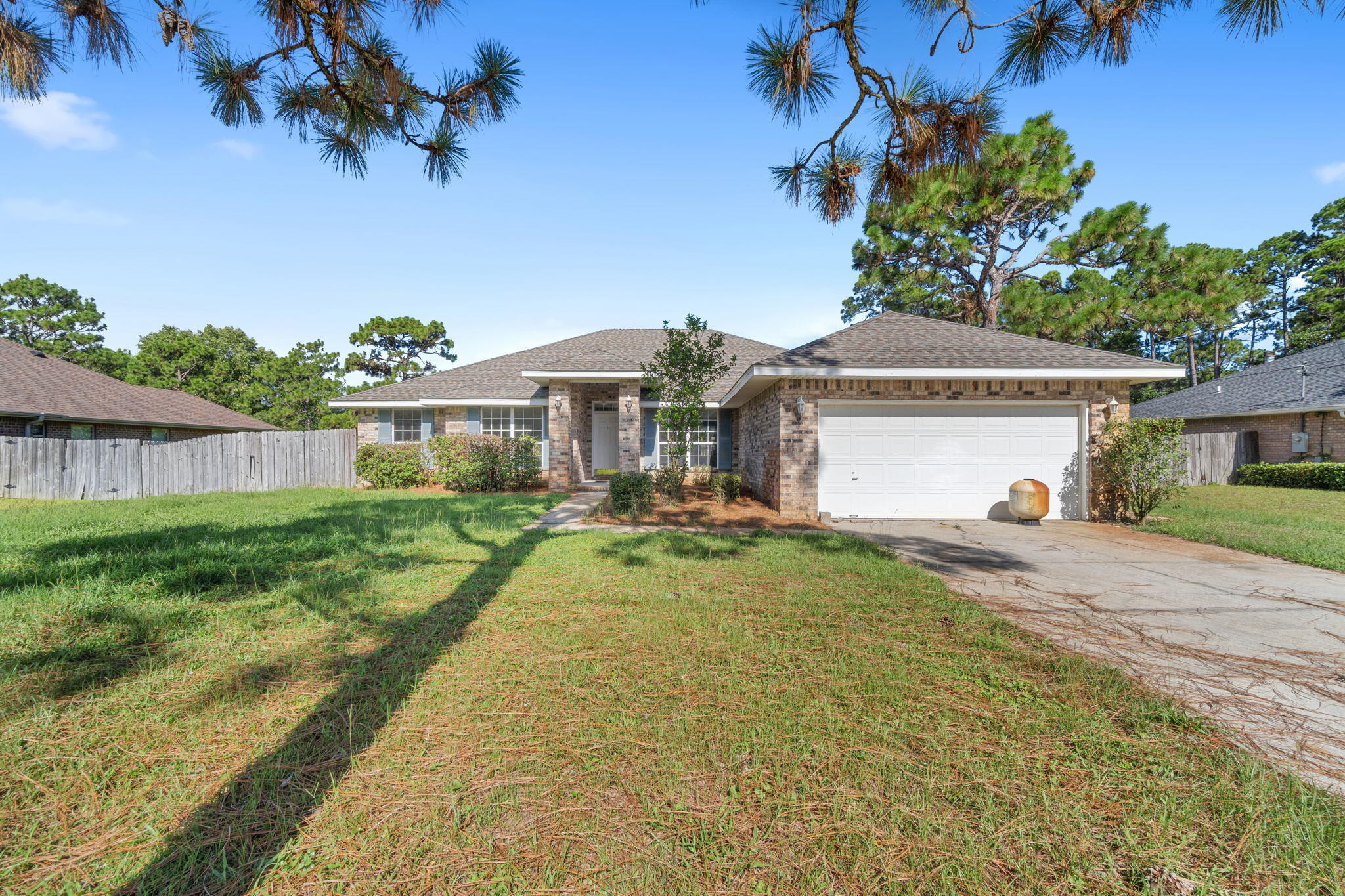 2005 Cardinal Lane Navarre, FL 32566 - Photo 4 of 63 a front view of a house with a yard and potted plants