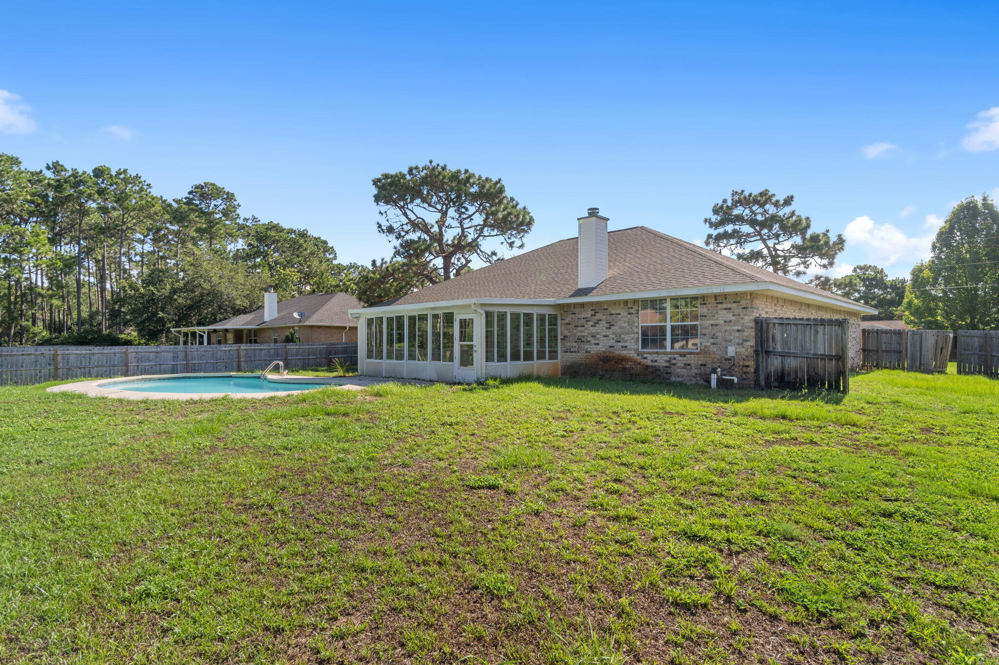 2005 Cardinal Lane Navarre, FL 32566 - Photo 44 of 63 a front view of a house with a garden