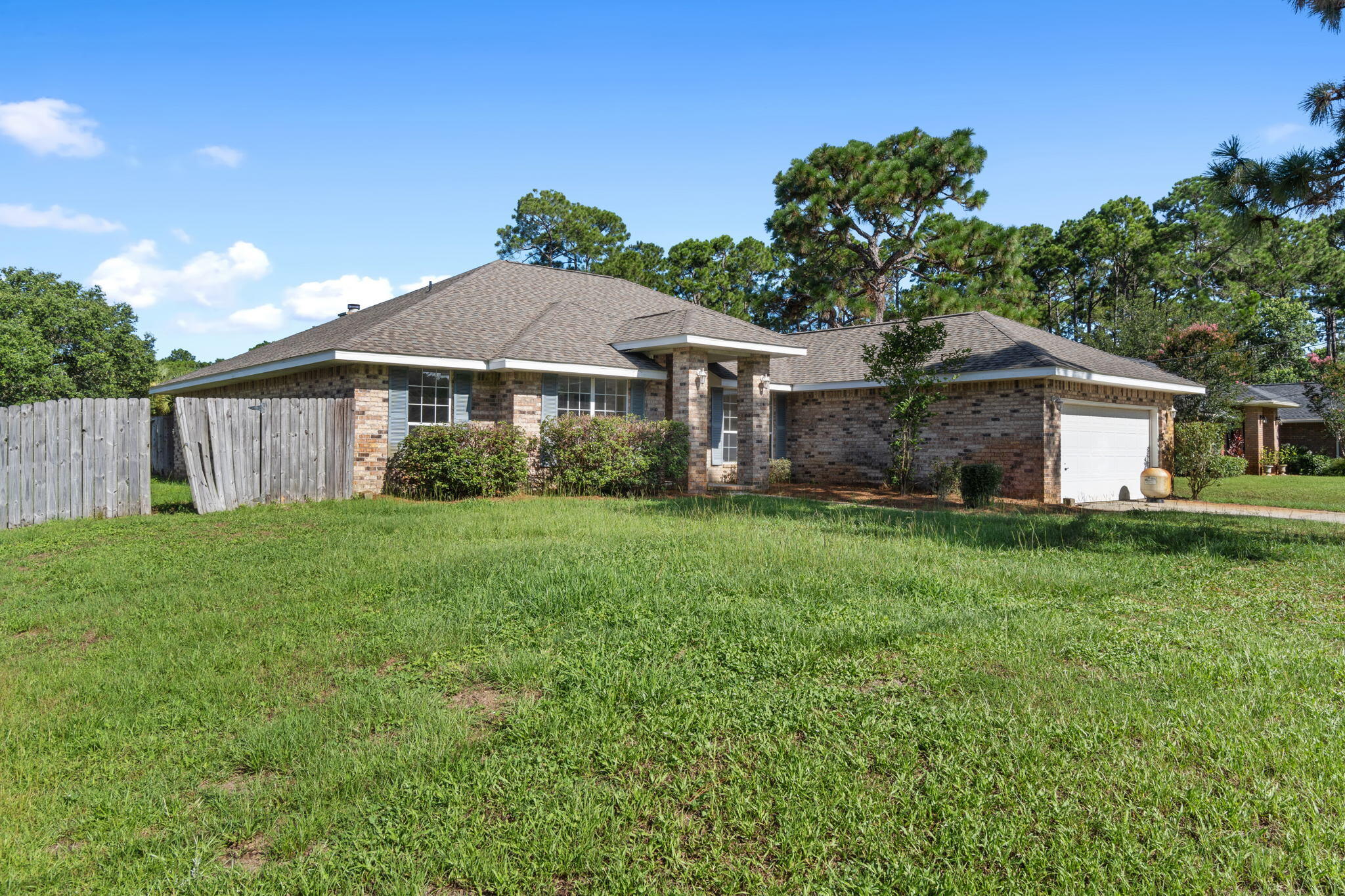 2005 Cardinal Lane Navarre, FL 32566 - Photo 5 of 63 a front view of a house with a garden