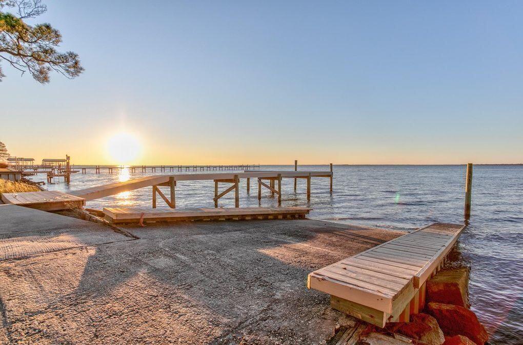 2005 Cardinal Lane Navarre, FL 32566 - Photo 58 of 63 a view of a roof deck with wooden floor and fence