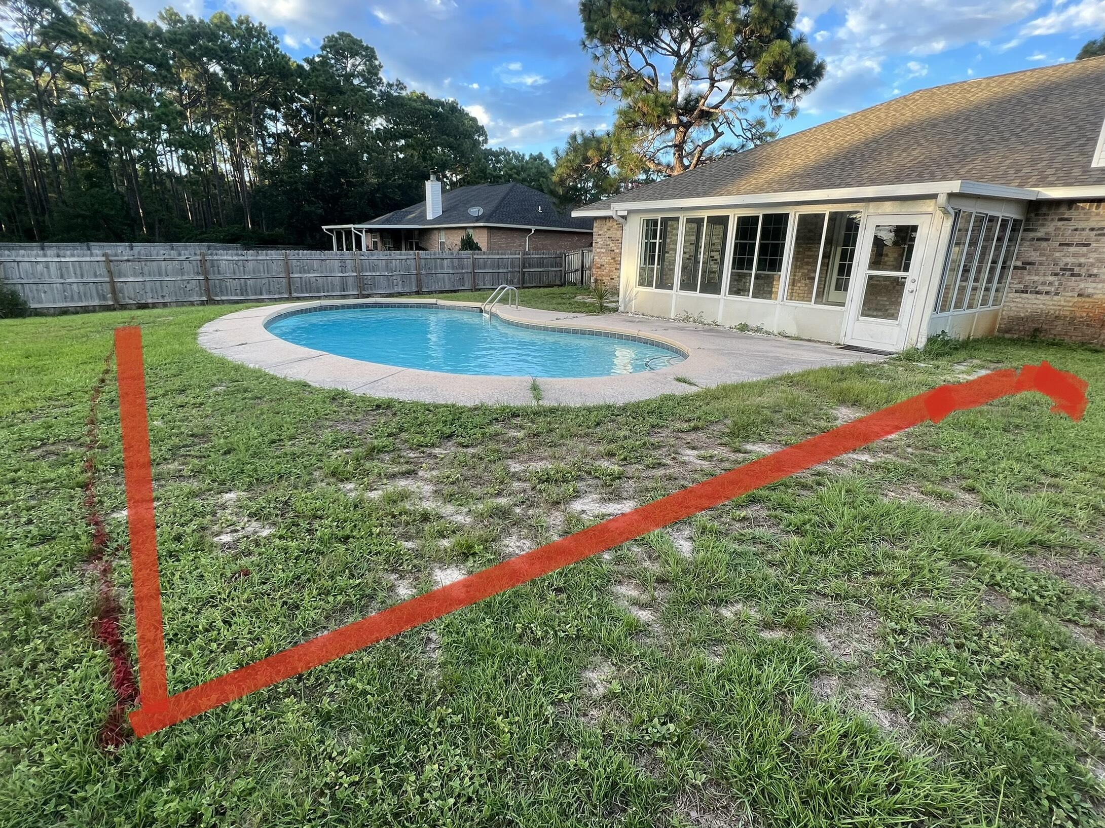 2005 Cardinal Lane Navarre, FL 32566 - Photo 62 of 63 a view of a house with swimming pool and yard