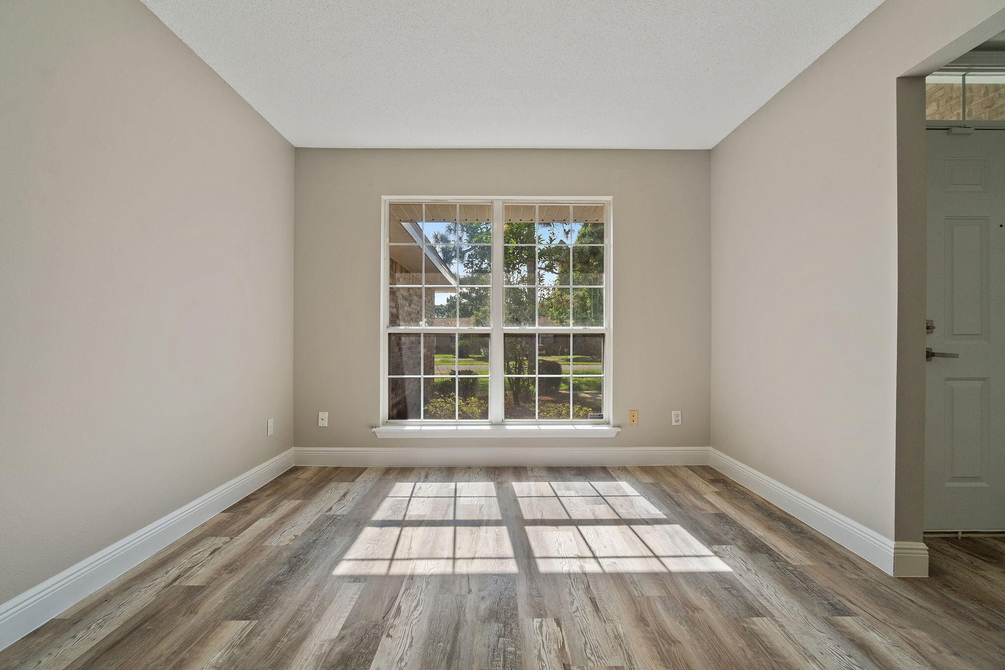 2005 Cardinal Lane Navarre, FL 32566 - Photo 8 of 63 an empty room with wooden floor and windows