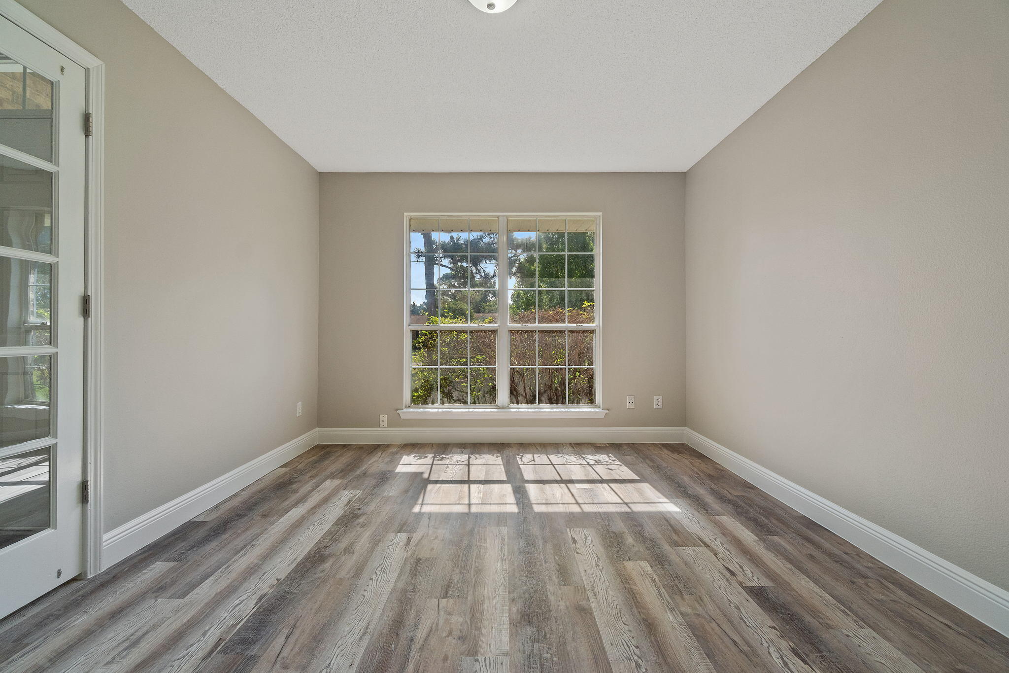 2005 Cardinal Lane Navarre, FL 32566 - Photo 10 of 63 a view of an empty room with wooden floor and a window