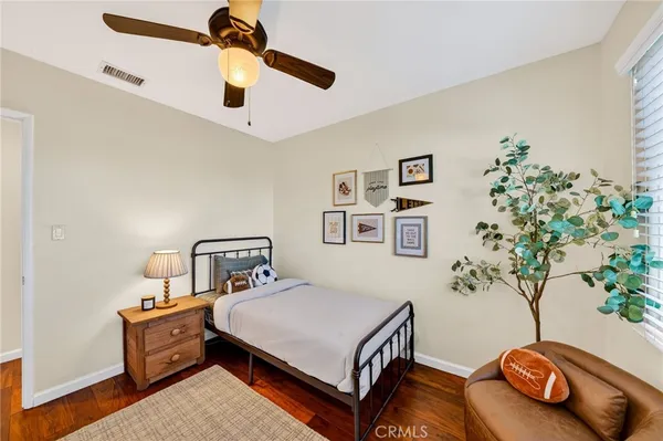 a bedroom with a bed and a potted plant