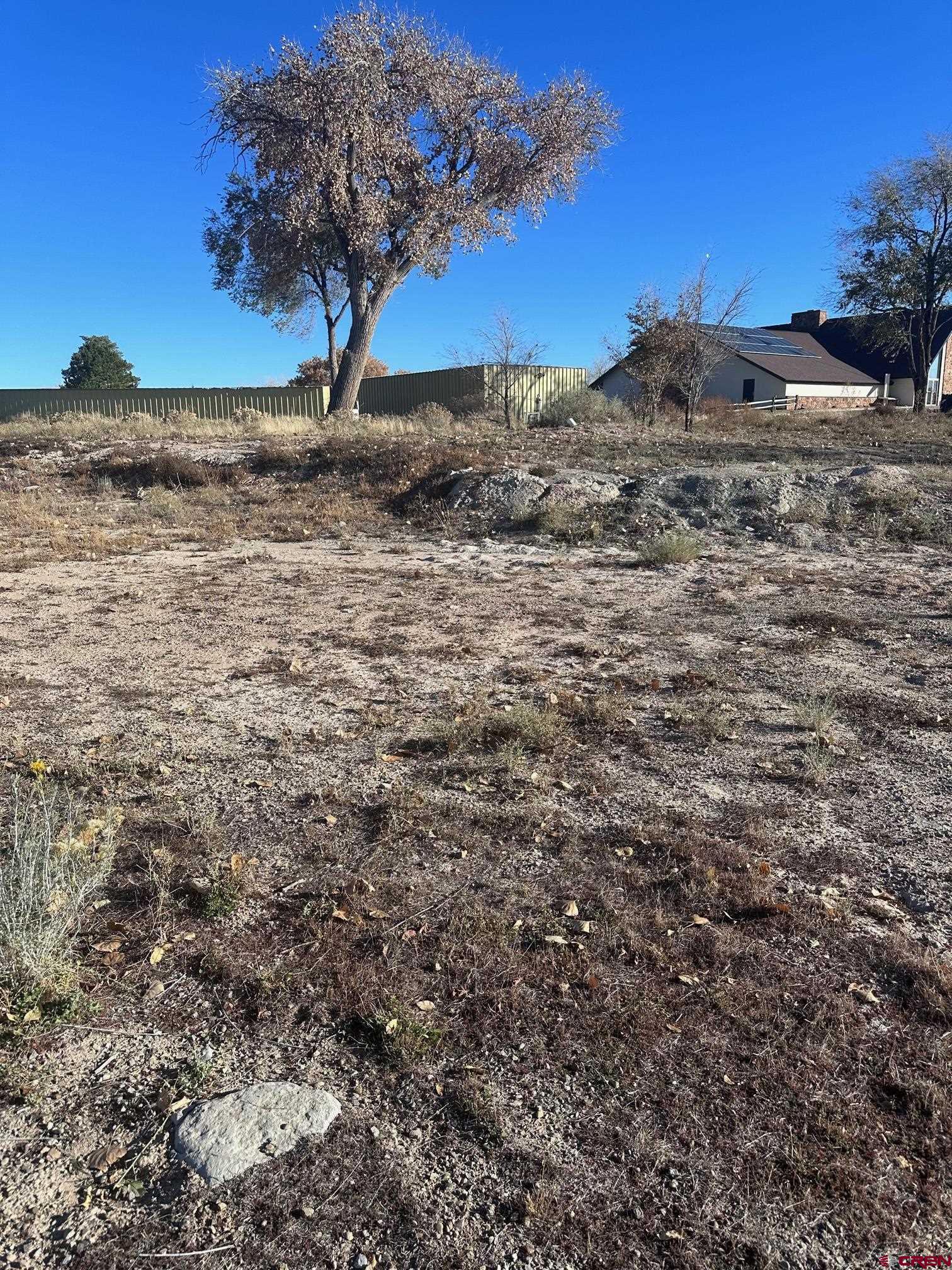 Tbd Tbd Par Drive Cortez, CO 81321 - Photo 7 of 9 a view of a dry yard with wooden fence