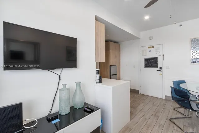 a room with a flat screen tv and a couch