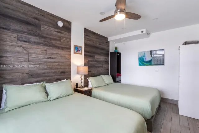 a bedroom with bed and ceiling fan