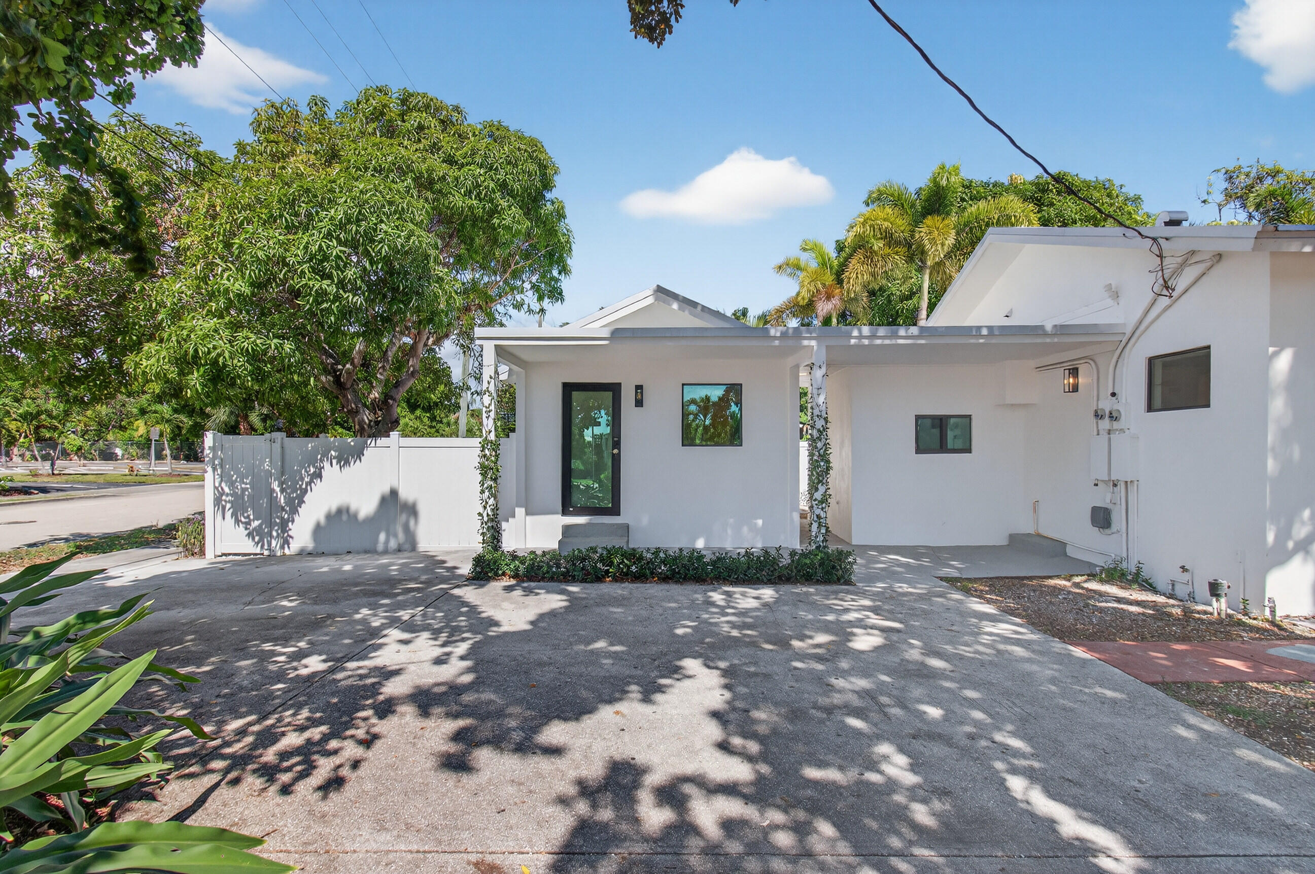 515 Northwest 1st Street, Unit 1 Delray Beach, FL 33444 - Photo 2 of 35 a view of a house with a small yard and floor to ceiling window