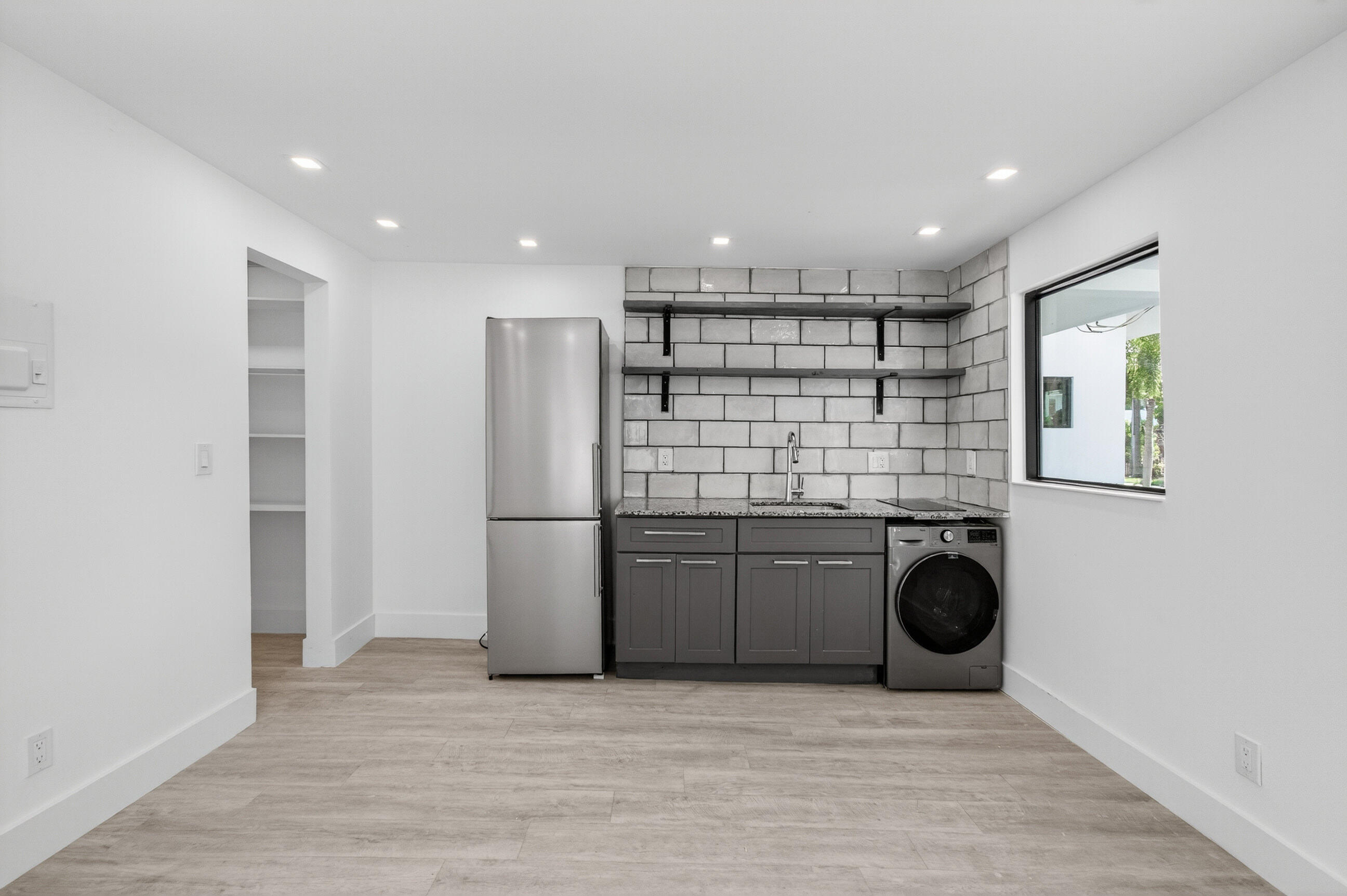 515 Northwest 1st Street, Unit 1 Delray Beach, FL 33444 - Photo 7 of 35 a kitchen with refrigerator and cabinets