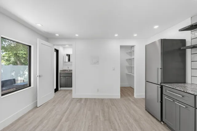 a view of walk in closet with racks on the wall