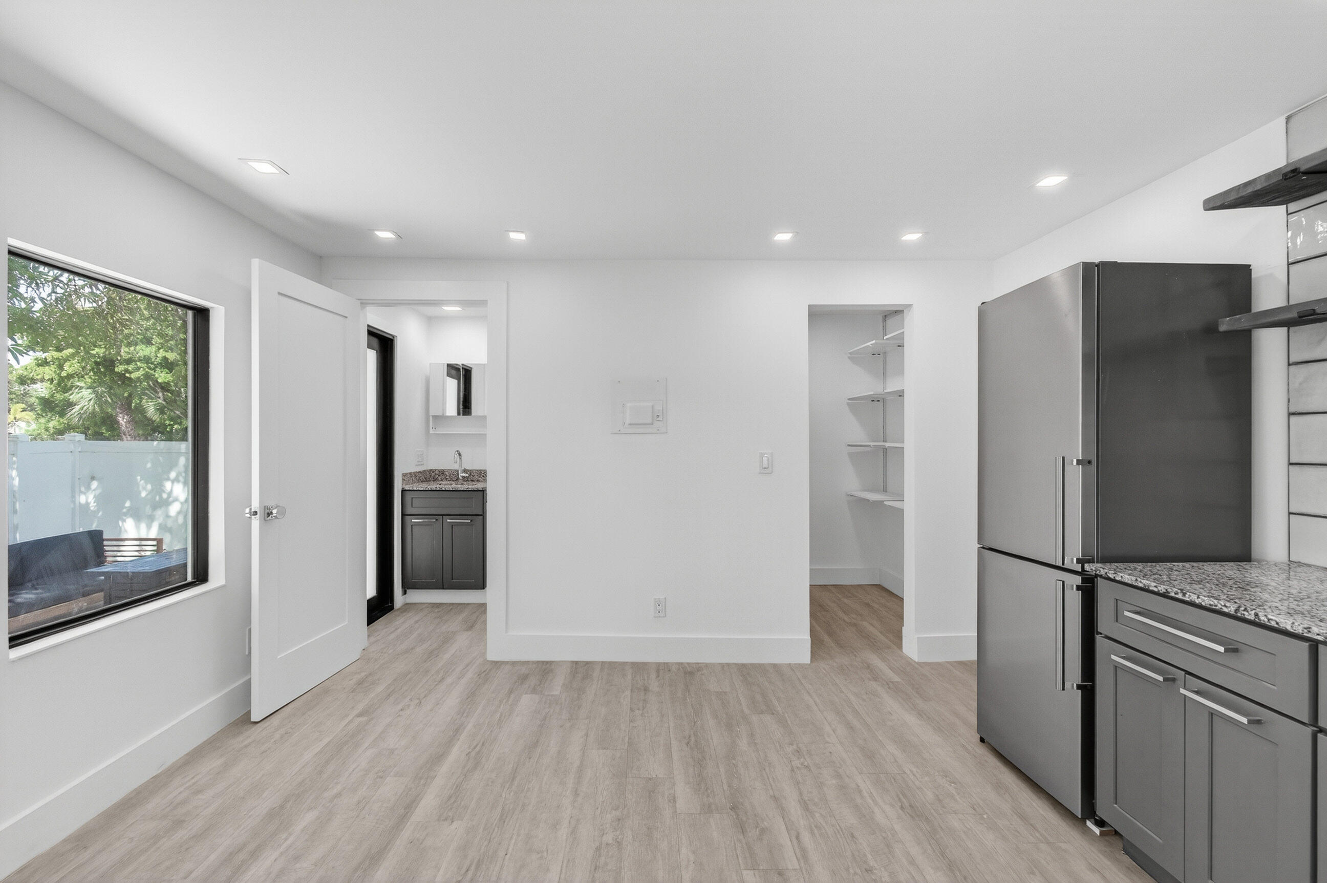 515 Northwest 1st Street, Unit 1 Delray Beach, FL 33444 - Photo 8 of 35 a view of a refrigerator in kitchen and wooden floor