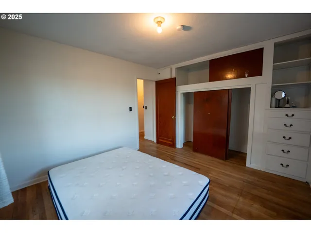 a view of an empty room with cabinet and flat screen tv