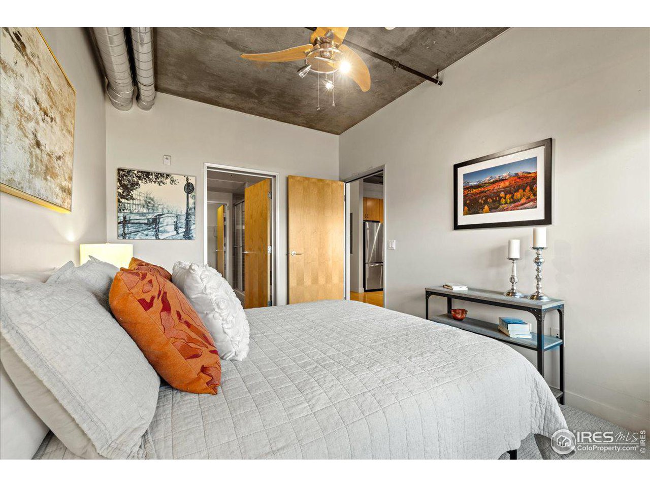 2229 Blake Street, Unit 402 Denver, CO 80205 - Photo 12 of 26 a bedroom with a bed and a painting on the wall