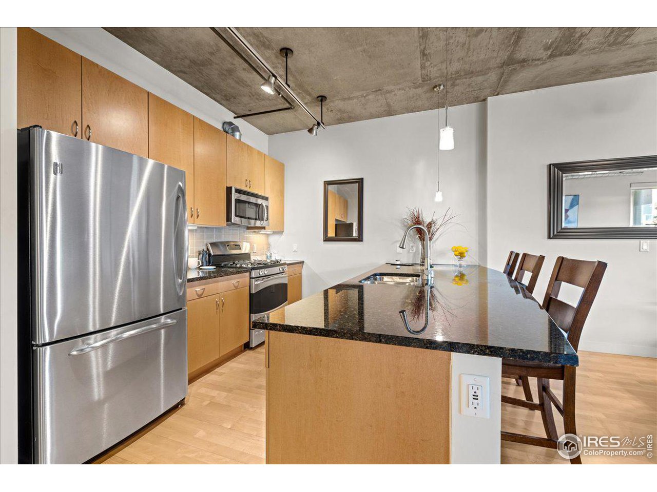 2229 Blake Street, Unit 402 Denver, CO 80205 - Photo 2 of 26 a kitchen with kitchen island a appliances a refrigerator a sink and a refrigerator