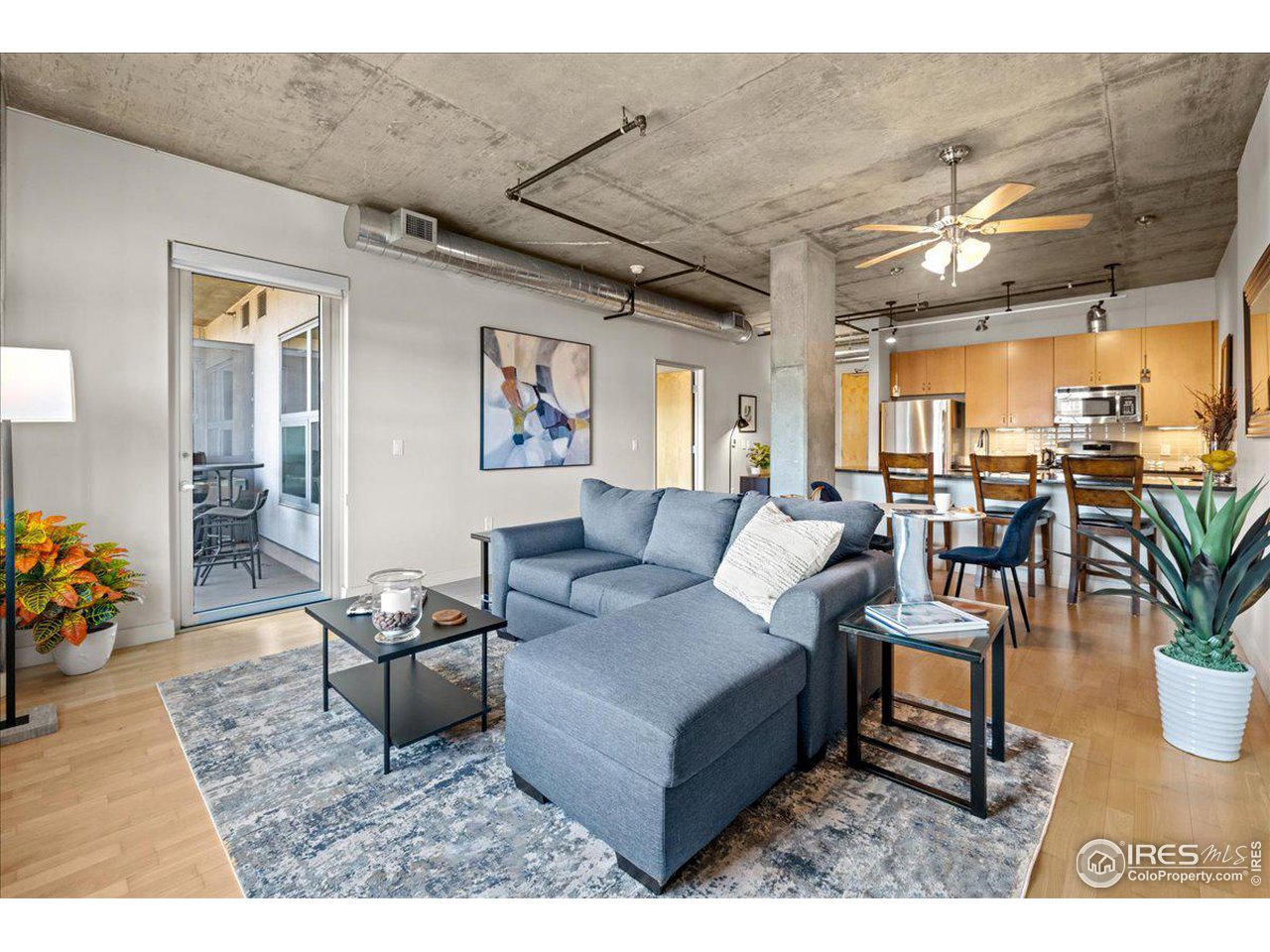 2229 Blake Street, Unit 402 Denver, CO 80205 - Photo 5 of 26 a living room with furniture and potted plants