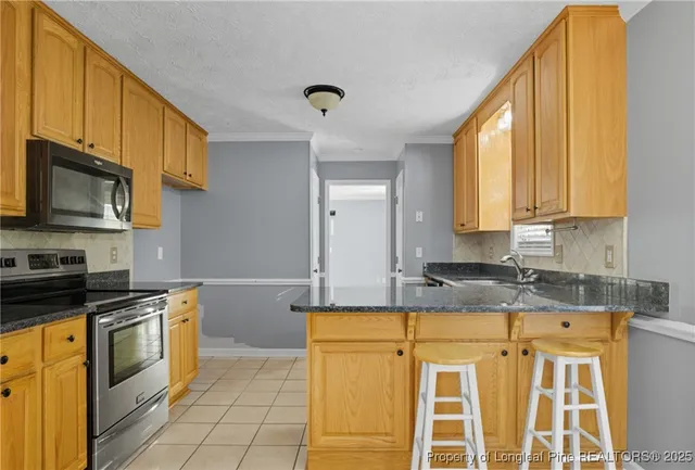 a kitchen with granite countertop a stove a sink and a granite counter tops