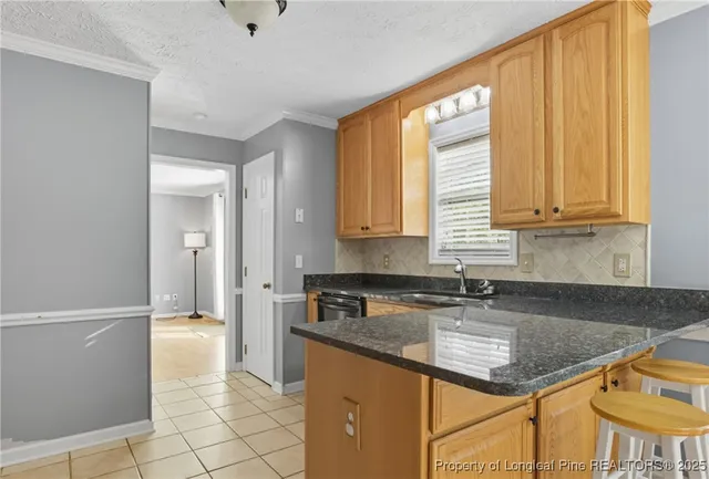 a kitchen with stainless steel appliances granite countertop a sink and a white cabinets