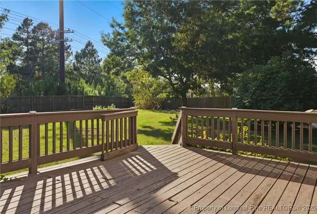 a view of wooden deck and a yard
