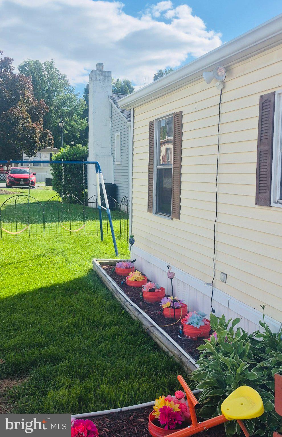 205 Robwood Road Dundalk, MD 21222 - Photo 14 of 14 Charming home with vibrant garden blooms.