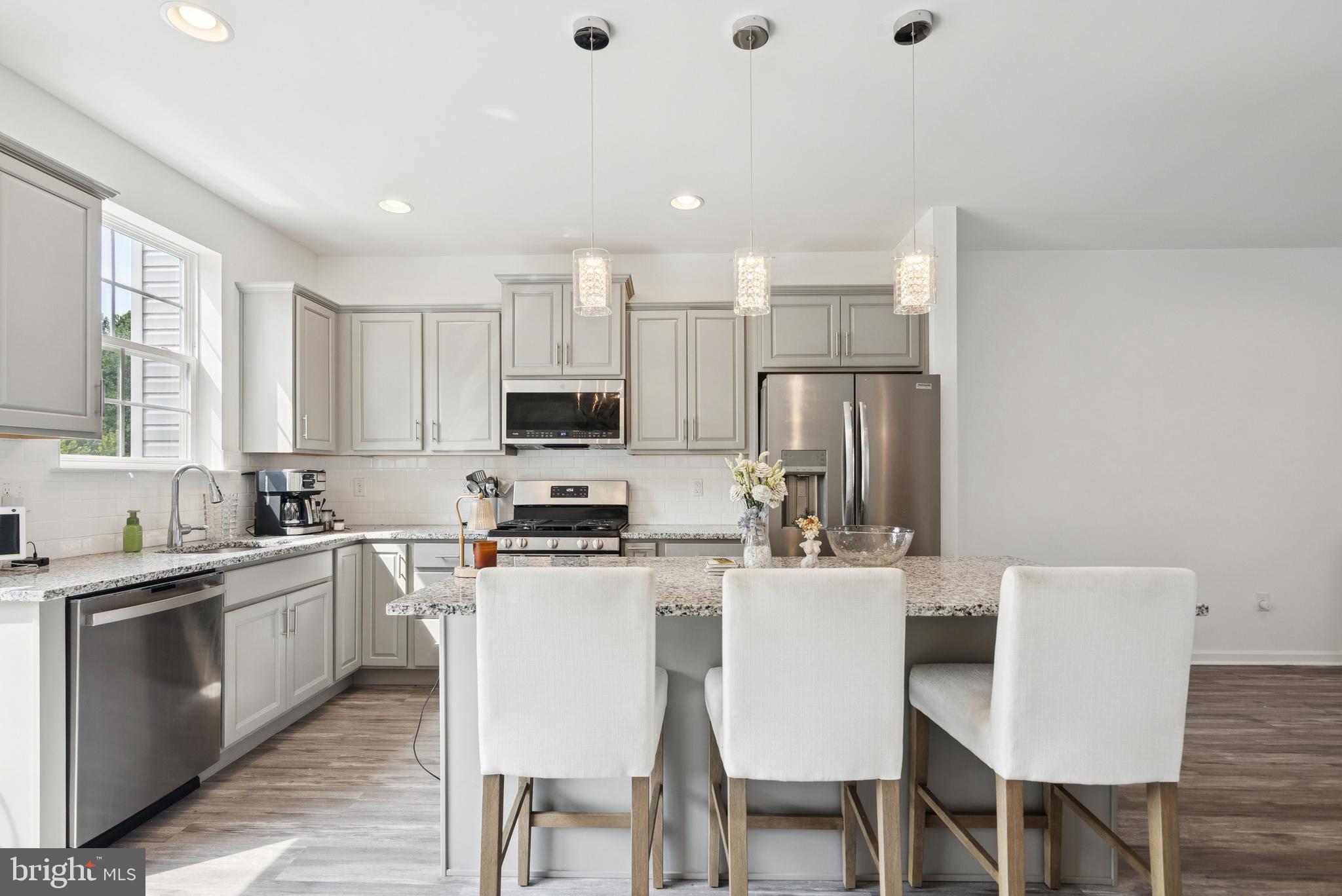 94 Aviary Road Thorofare, NJ 08086 - Photo 11 of 24 a kitchen with stainless steel appliances a table chairs refrigerator and cabinets