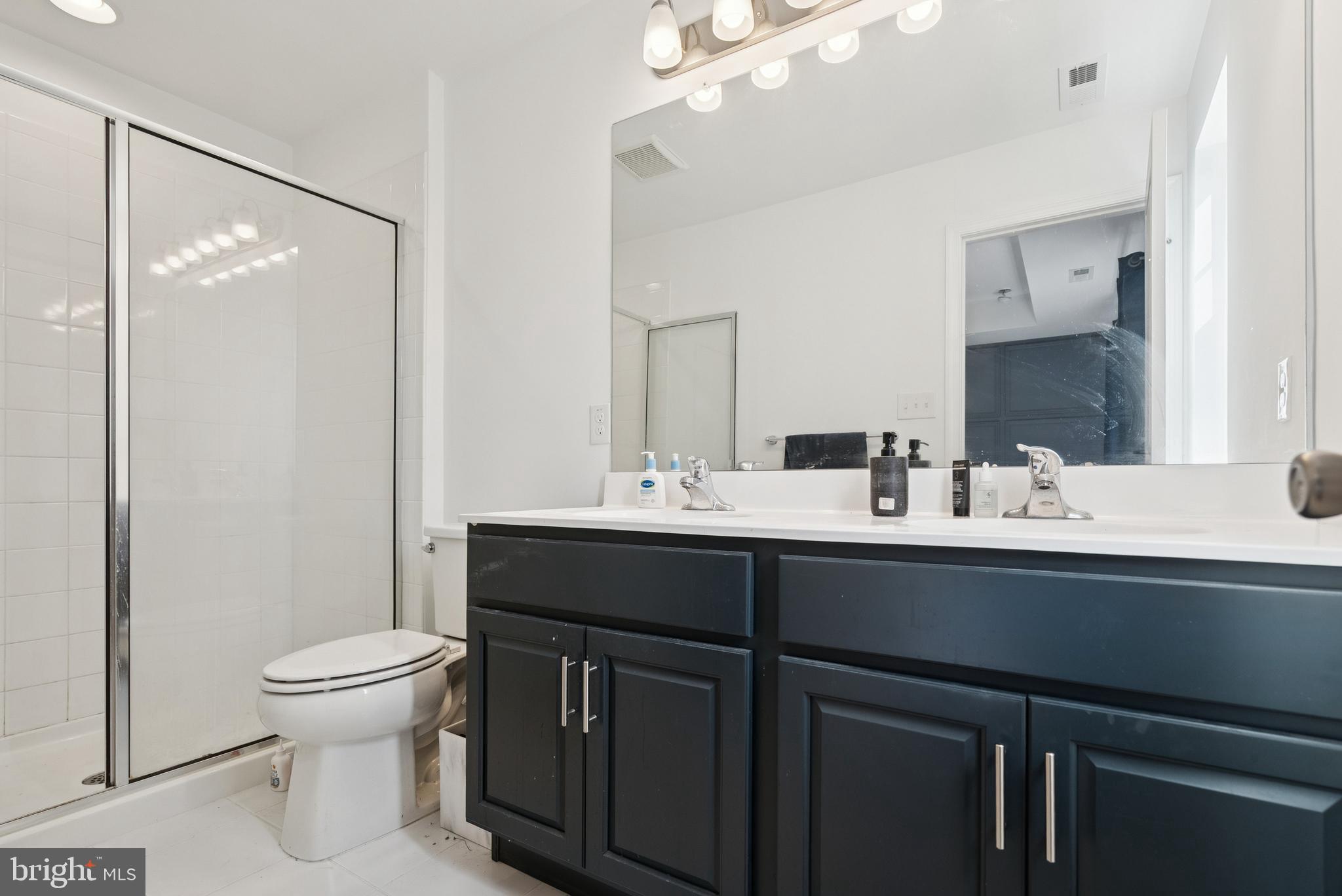 94 Aviary Road Thorofare, NJ 08086 - Photo 20 of 24 a bathroom with a sink a toilet and a mirror