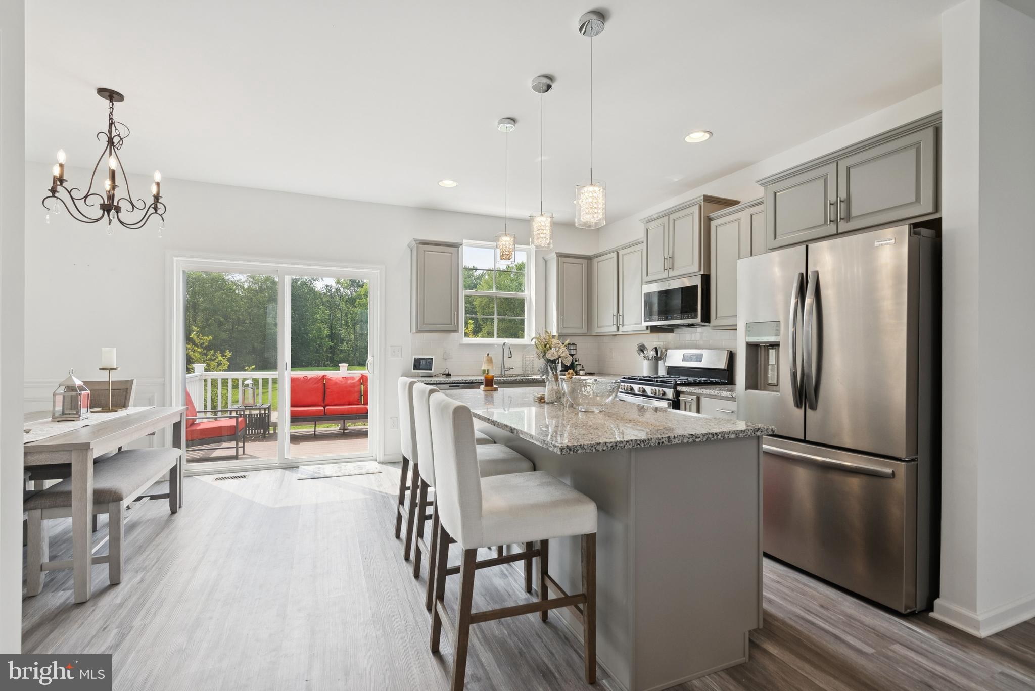 94 Aviary Road Thorofare, NJ 08086 - Photo 10 of 24 a kitchen with stainless steel appliances a dining table chairs refrigerator and sink