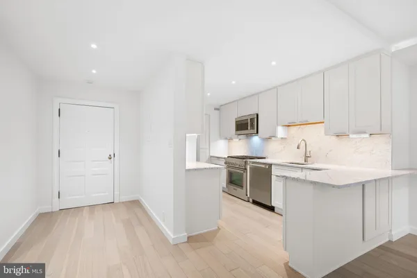 a kitchen with cabinets and stainless steel appliances