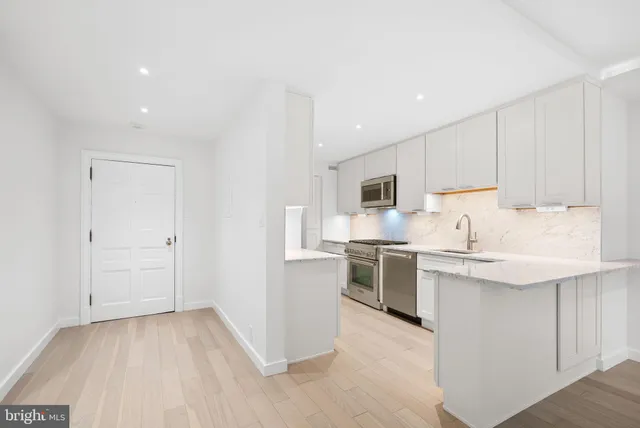 a kitchen with cabinets and stainless steel appliances