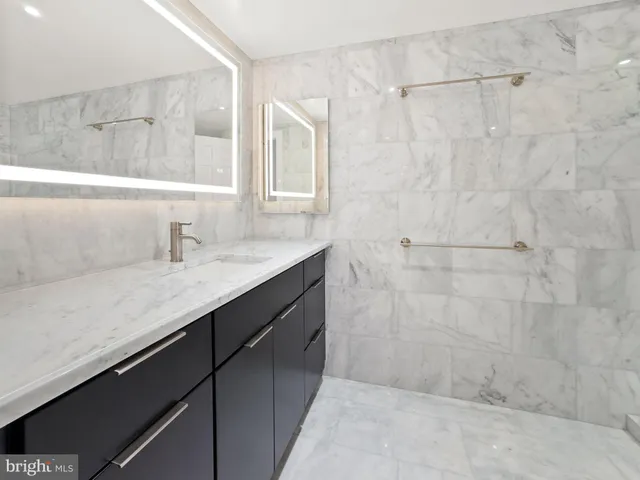 a bathroom with a shower and a sink