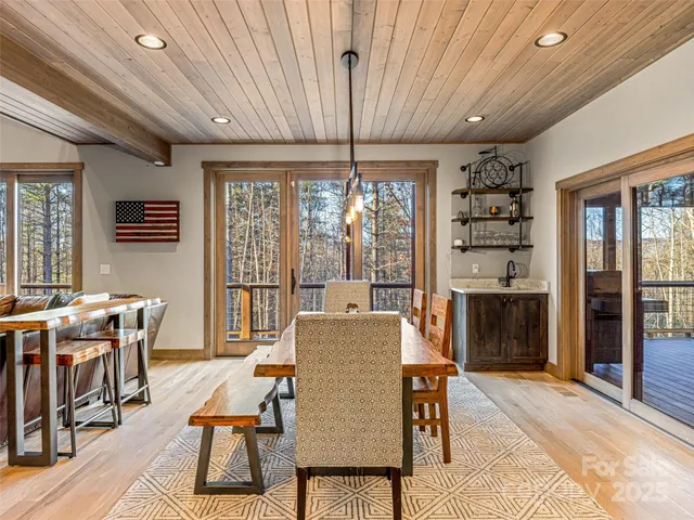 a dining room with furniture a chandelier and window