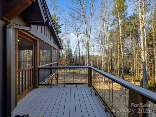 a view of balcony with wooden floor and fence
