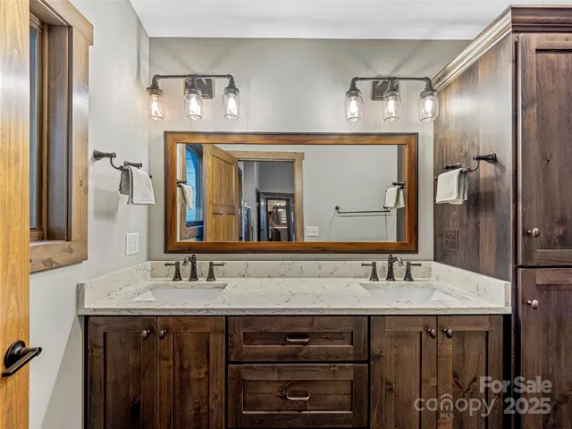 a bathroom with a double vanity sink and a mirror