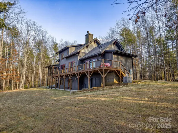 a view of a large house with large trees and a big yard