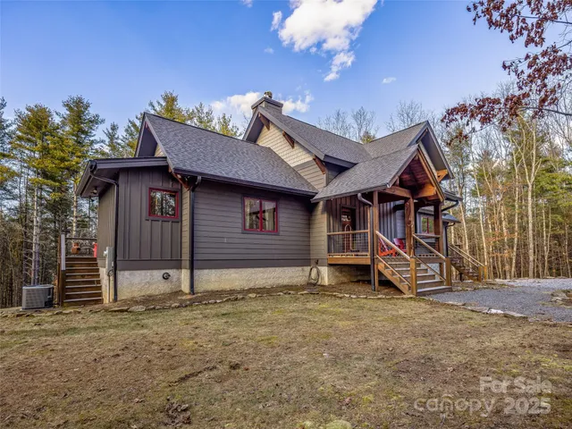 a view of a house with a yard and wooden fence