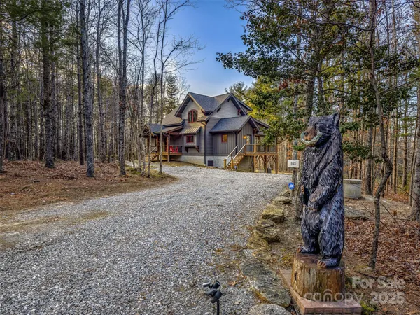 a view of a house with a yard and wooden fence