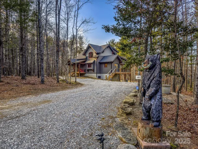 a view of a house with a yard and wooden fence