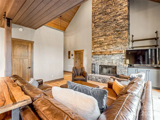 a living room with a couch a fireplace and a flat screen tv