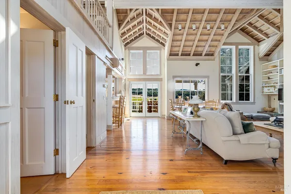 a living room with furniture a fireplace and wooden floor