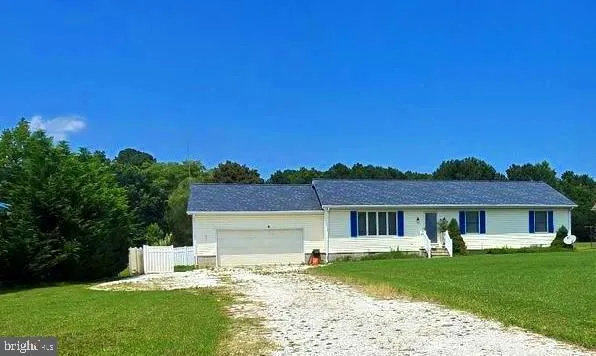 a front view of a house with a garden and yard