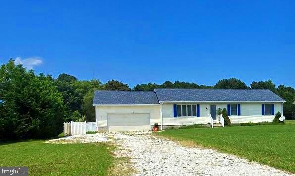 a front view of a house with a garden and yard