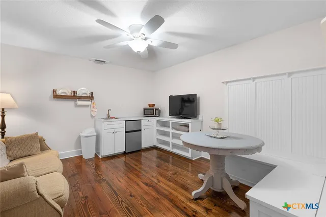 a view of a dining room with furniture and wooden floor