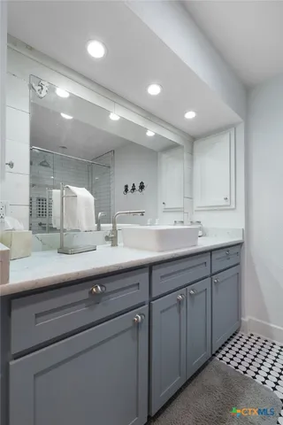 a kitchen with a sink and cabinets