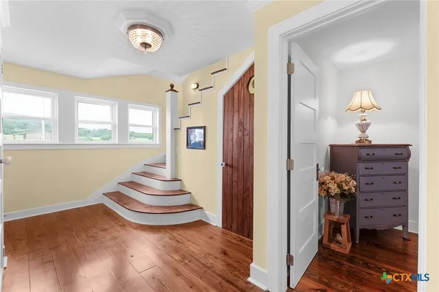 a view of an entryway with wooden floor