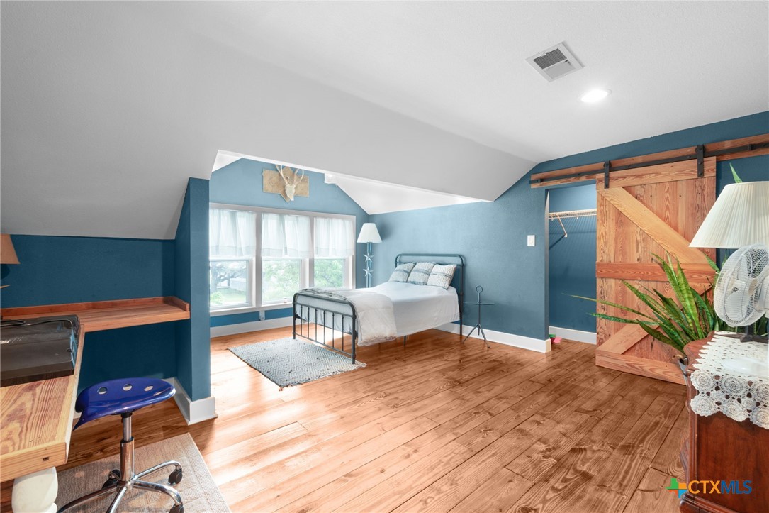 951 Moseley Road Copperas Cove, TX 76522 - Photo 25 of 43 a bedroom with a bed and wooden floor