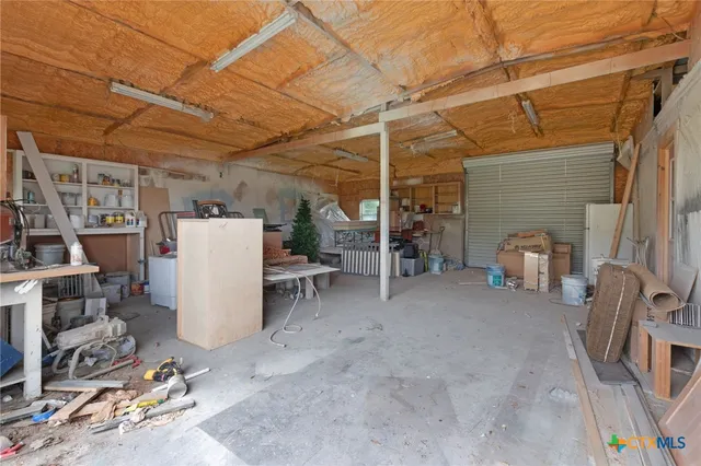 a open kitchen with white cabinets stove and refrigerator