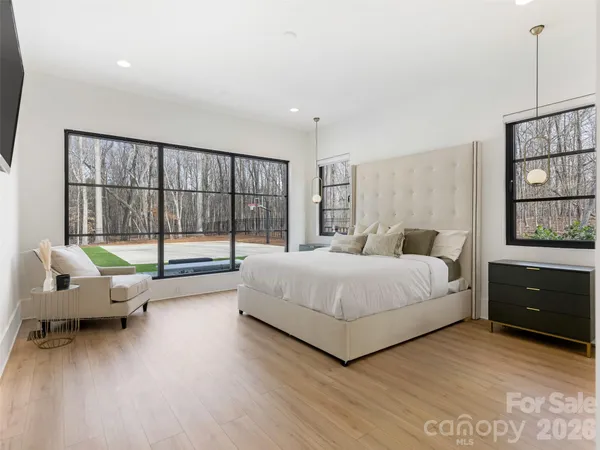 a bedroom with a bed and a dresser next to a window