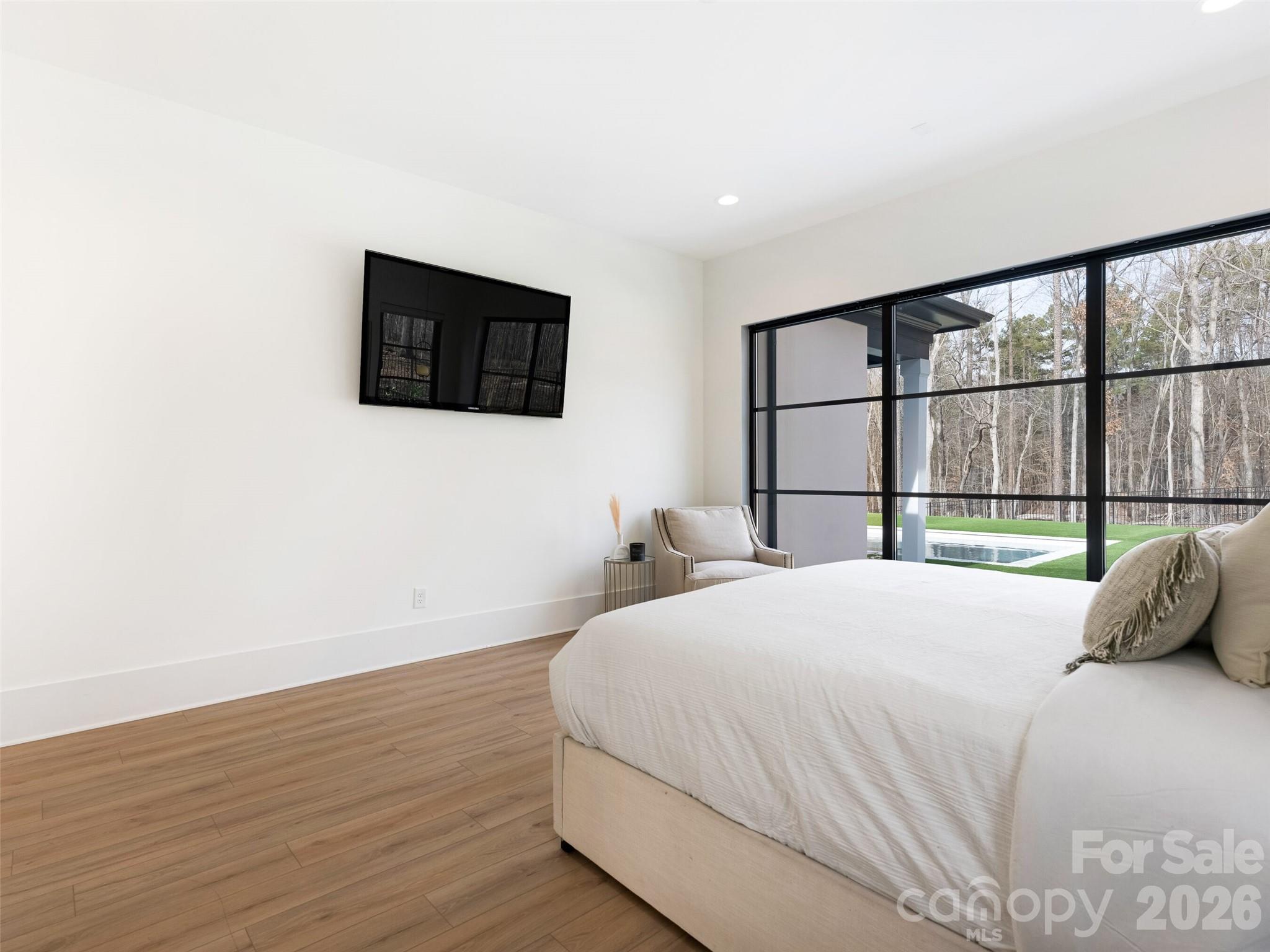 6017 Oxfordshire Road Waxhaw, NC 28173 - Photo 20 of 48 a bedroom with a bed and a large window