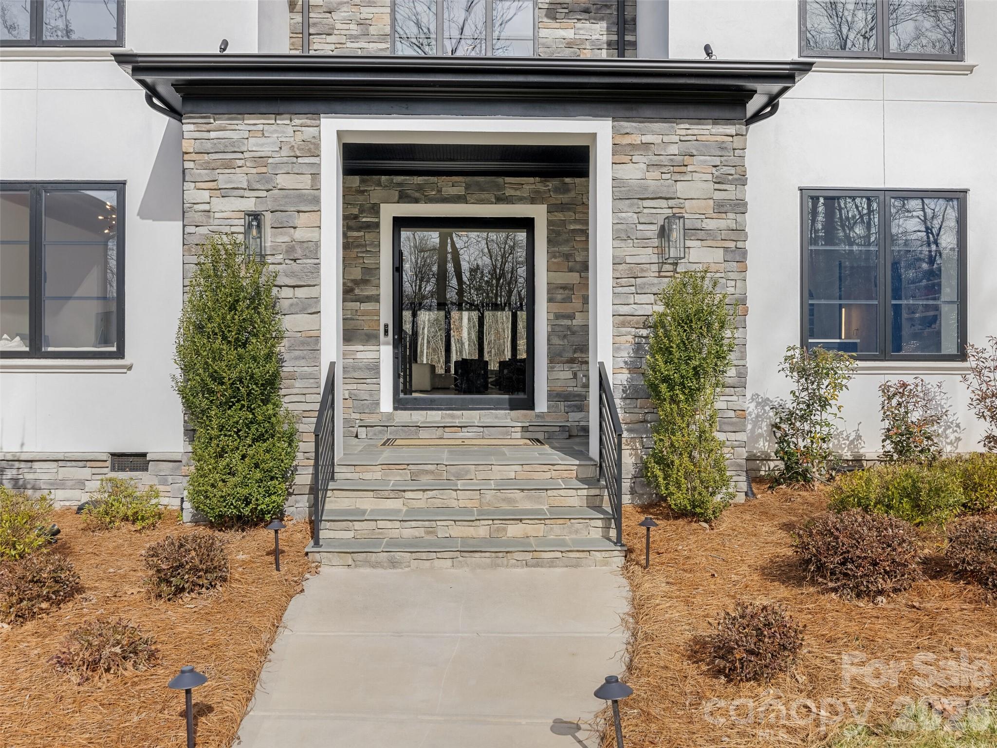 6017 Oxfordshire Road Waxhaw, NC 28173 - Photo 2 of 48 a view of the entrance of the house and a yard