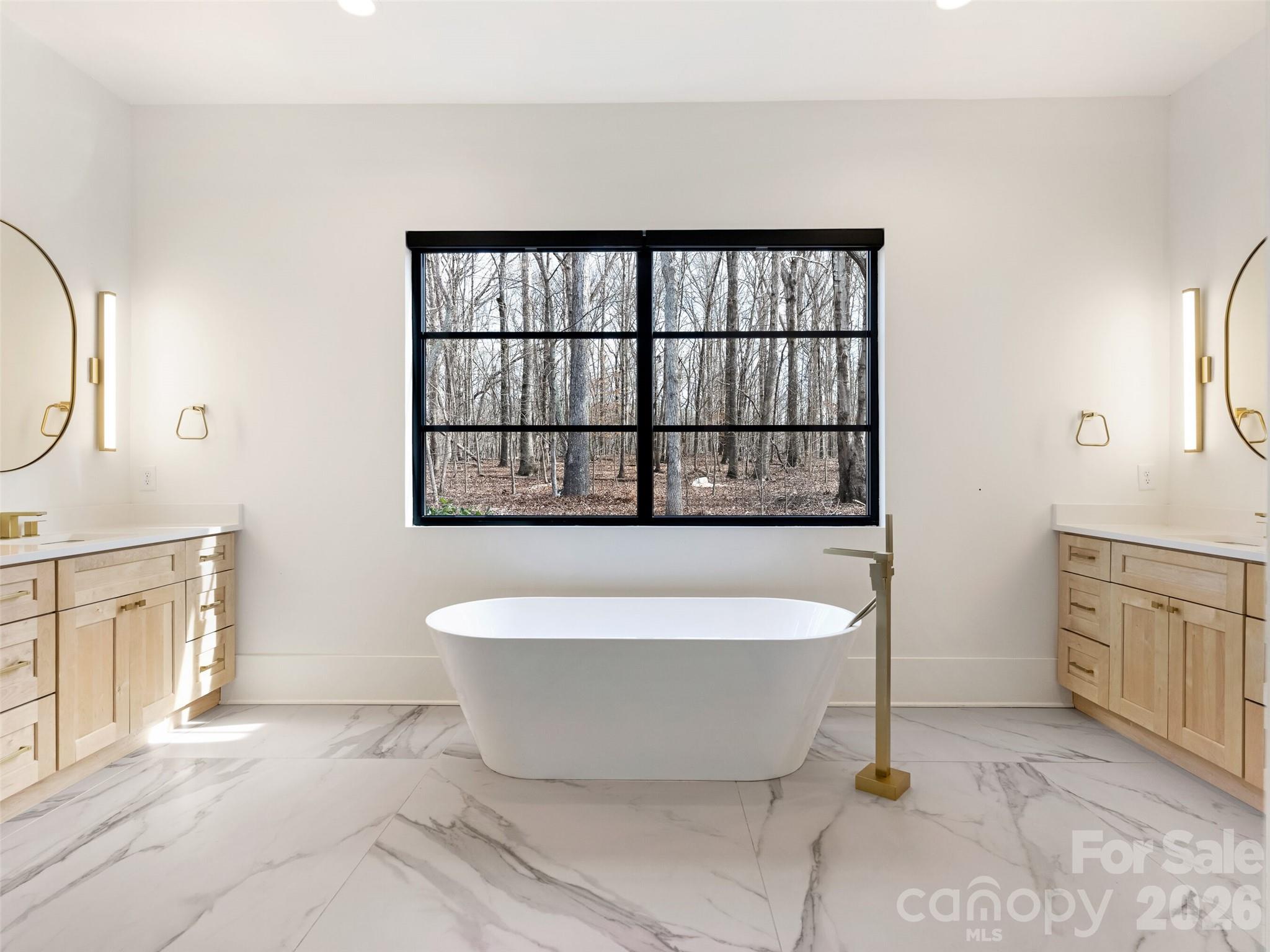 6017 Oxfordshire Road Waxhaw, NC 28173 - Photo 22 of 48 a large white tub sitting in a bathroom